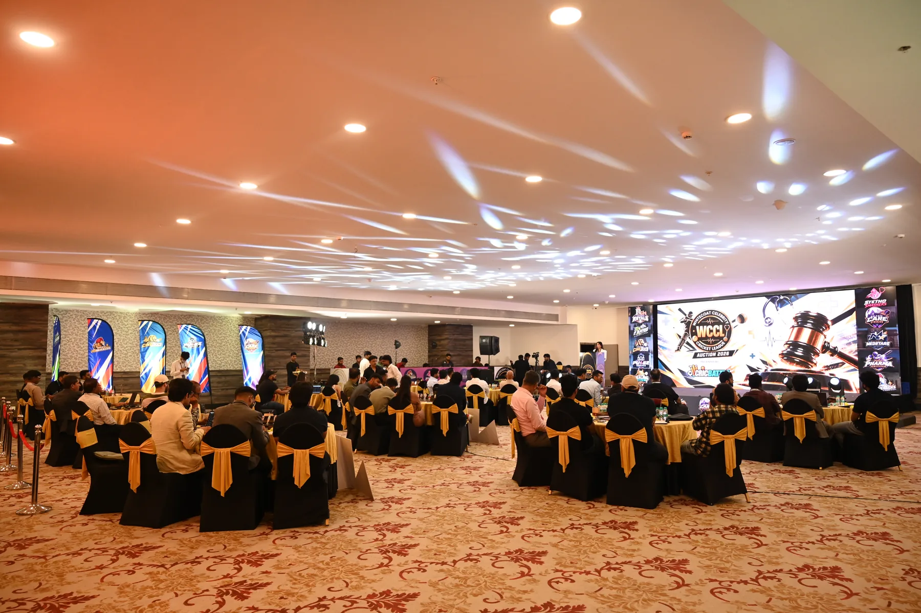 WCCL Grand Auction room with franchise tables and stage in Pune
